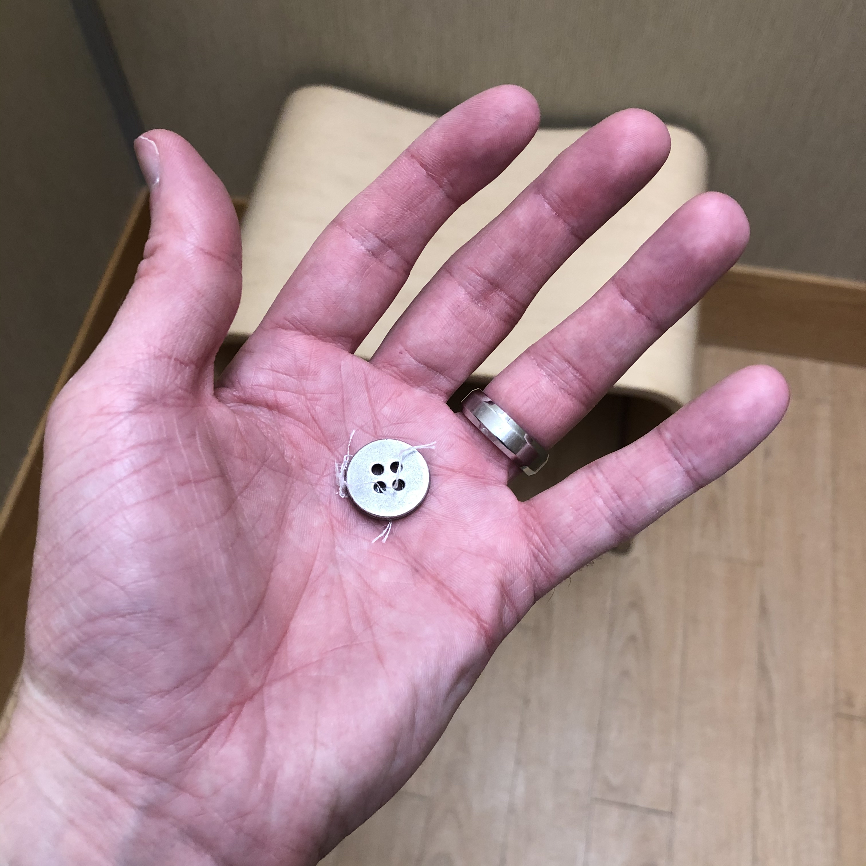 Dave holds his button in his hand.